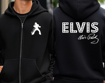May include: Black zip-up hoodie featuring a white silhouette of a performer on the front. The back of the hoodie displays the name "ELVIS" in white, with a dotted font, and the signature "Elvis Presley".