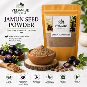 May include: A tan pouch labeled VEDAVIBE NATURALS JAMUN SEED POWDER containing brown powder, with a wooden bowl filled with the same powder, a wooden scoop, and fresh dark purple jamun fruit with green leaves arranged on a white surface.