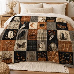 May include: A rectangular throw blanket featuring a patchwork design of various illustrations including owls, ghosts, black cats, moths, pumpkins, crescent moons, skeleton hands, and floral arrangements in a color palette of black, orange, and cream.