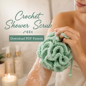 May include: A light green crocheted shower scrub with a ruffled texture and a small hanging loop featuring a bead. The image includes the text Crochet Shower Scrub and Download PDF Pattern in a dark green font against a light background.