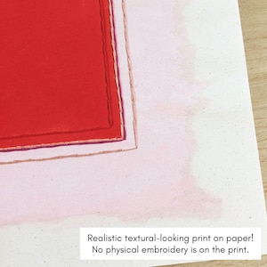 May include: Close-up of a print on paper with a red rectangular design. The design is bordered by thin lines of purple, white, and tan. The text at the bottom reads: "Realistic textural-looking print on paper! No physical embroidery is on the print."