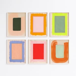 May include: Six framed abstract art prints. Each print features a rectangular or square shape in the center, surrounded by a contrasting color. The color palette includes pink, green, orange, blue, and red, with a neutral background.