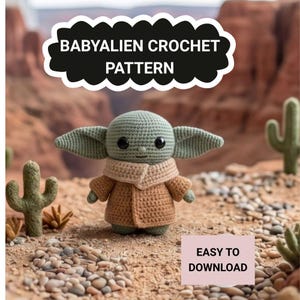 May include: A crocheted Baby Alien doll, with a green head and large ears, wearing a tan coat and scarf. The image includes text that reads "BABYALIEN CROCHET PATTERN" and "EASY TO DOWNLOAD". The doll is set against a desert backdrop with cacti.