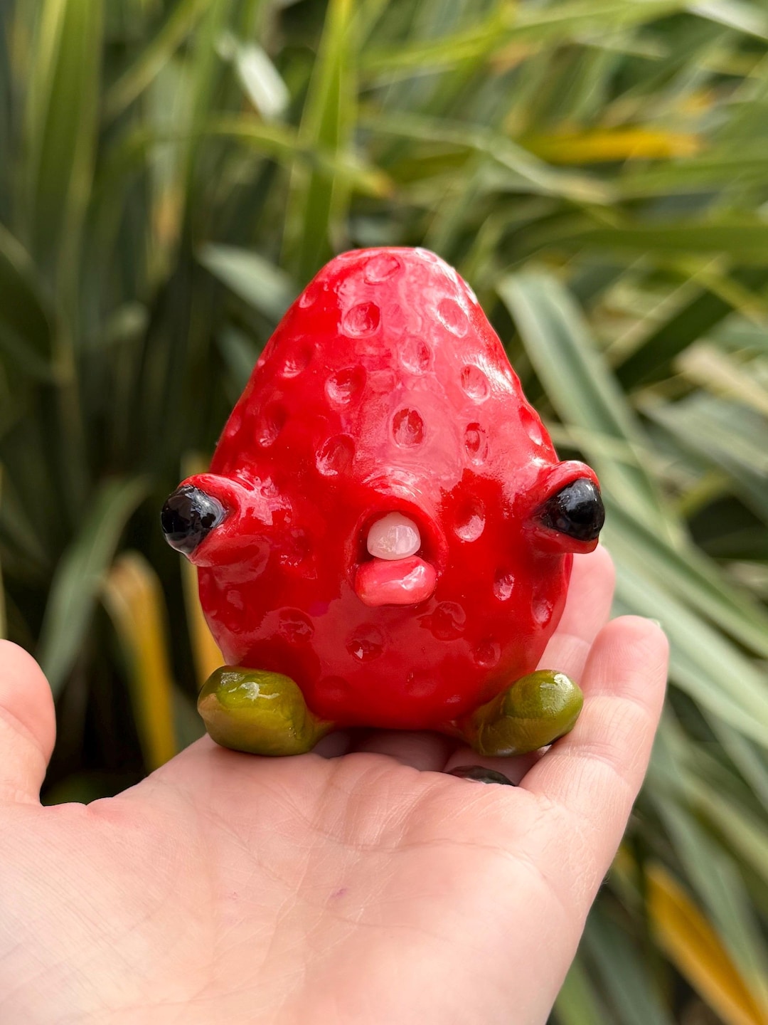 Cursed strawb baby, a red strawberry creature