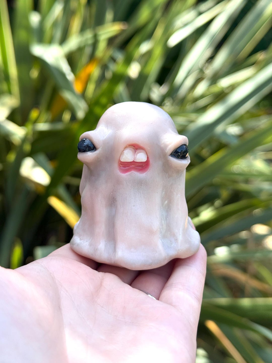 Toothy cursed ghost baby with two big teeth