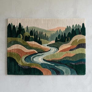 May include: A rectangular tufted wall hanging featuring a landscape scene with a winding river flowing through rolling hills and dense evergreen forests. The color palette includes shades of forest green, olive, sage, terracotta, and cream.