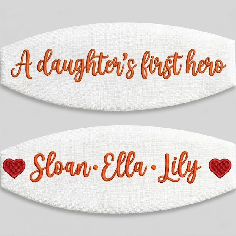 May include: Two white oval-shaped fabric patches featuring orange embroidered text. The top patch reads A daughter's first hero. The bottom patch displays the names Sloan, Ella, and Lily in orange, flanked by two small red embroidered hearts.