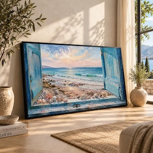 May include: A rectangular framed wall art print depicting an open window view of a beach at sunset. The scene features weathered blue wooden shutters, a sandy shoreline with scattered seashells, turquoise ocean waves, and a soft pink sky.