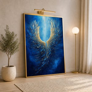 May include: A rectangular wall art piece in a gold frame featuring a central depiction of large, textured wings in shades of deep blue and metallic gold. The wings are set against a swirling, ethereal blue background with light radiating from the center.