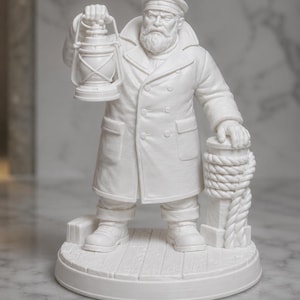 May include: A white matte figurine of a bearded sailor wearing a double-breasted coat and a cap. The sailor holds a lantern in one hand and rests the other on a bollard wrapped in rope. The figure stands on a circular base with a plank floor design.