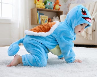 May include: A light blue plush onesie featuring a hood with a Squirtle face, a brown turtle shell on the back with white trim, and a matching tail. The soft, fuzzy fabric covers the arms and legs, designed as a character costume for a child.