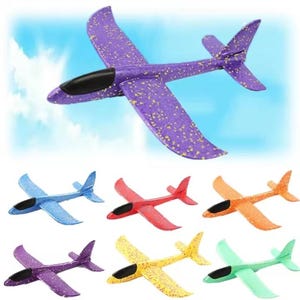 May include: A collection of seven foam glider aeroplanes in various colours including purple with yellow speckles, blue, red, orange, yellow, and light green. Each aeroplane features a sleek, aerodynamic design with a black cockpit canopy.