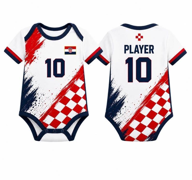 May include: A white baby bodysuit featuring a red and white checkered pattern, navy blue trim, and the number 10. The front displays the Croatian flag, while the back shows the text PLAYER above the number 10, with red and navy blue brush strokes.