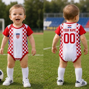 May include: A white and red checkered bodysuit featuring the Croatian coat of arms on the front and the text YOUR NAME with the number 00 on the back. The garment has short red sleeves, white trim, and a snap closure at the bottom crotch area.