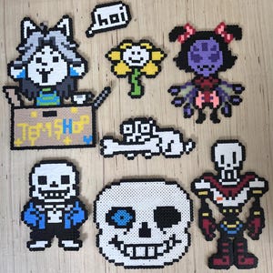 May include: A collection of pixel art characters from the video game Undertale. The characters include Temmie in a box, Flowey, Muffet, a bone, Sans, a skull, and Papyrus. The word "hoi" is also present.