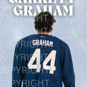May include: A navy blue hockey jersey with the name "GRAHAM" and the number "44" in white. The name "GARRETT GRAHAM" is displayed in large white letters above the jersey. The background has a light blue ice rink design.