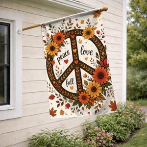 May include: A rectangular garden flag featuring a central peace sign symbol decorated with orange and yellow sunflowers and autumn leaves. The text "peace love fall" is written in black script within the symbol, accented by small orange hearts.