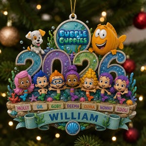 May include: A Bubble Guppies 2026 Christmas ornament featuring characters Molly, Gil, Goby, Deema, Oona, Nonny, and Zooli. The design includes a puppy, an orange fish, and a banner with the name William, all set against a textured underwater theme.