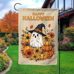 May include: A rectangular garden flag with a beige background featuring the text HAPPY HALLOWEEN in orange. The design displays a white ghost wearing a black witch hat, surrounded by orange pumpkins, yellow sunflowers, and autumn leaves.