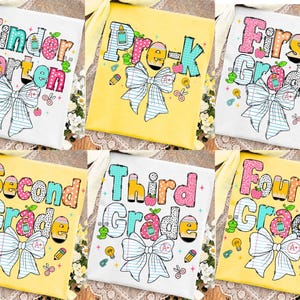 May include: A collection of six t-shirts in white and yellow, each featuring colorful, patterned text for school grades from Kindergarten to Fourth Grade. The designs include school supply graphics like pencils, apples, and a large plaid bow.