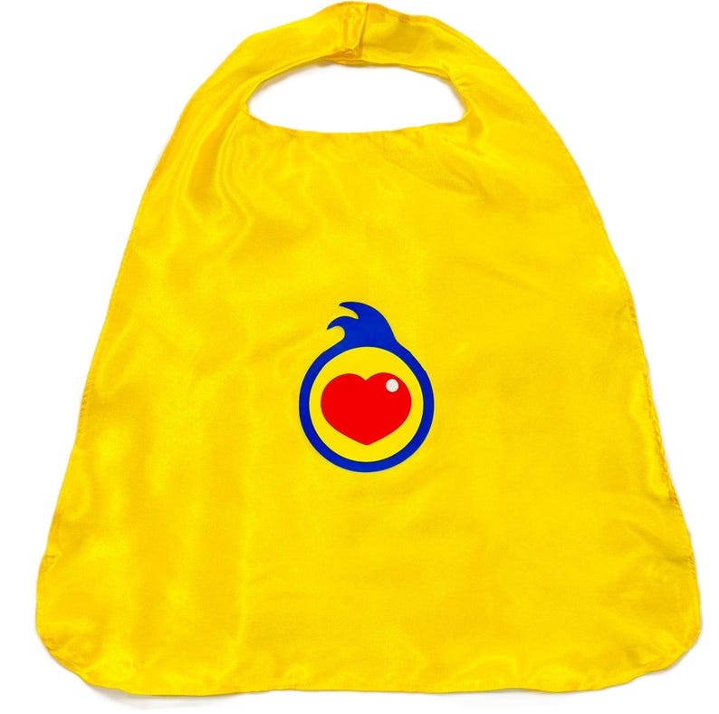 May include: A bright yellow superhero cape with a blue and red heart logo. The cape is made of a shiny, silky material and has a loop for the neck. The heart logo is in the center of the cape.