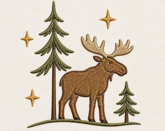 May include: An embroidery design featuring a brown moose with large antlers standing on a green grassy hill. The scene includes two green pine trees of different sizes and three gold four-pointed stars arranged around the moose on a cream background.