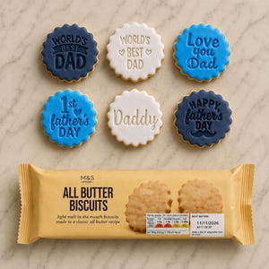 May include: Six round scalloped biscuits with icing in shades of navy blue, white, and light blue, featuring embossed text like World's Best Dad and Happy Father's Day. Below them is a yellow package of M&S Food All Butter Biscuits.