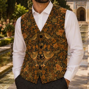 May include: A sleeveless waistcoat featuring a dark green background with a repeating pattern of golden-brown birds and floral motifs, worn over a crisp white long-sleeved button-down shirt, paired with dark grey trousers with a subtle textured pattern.