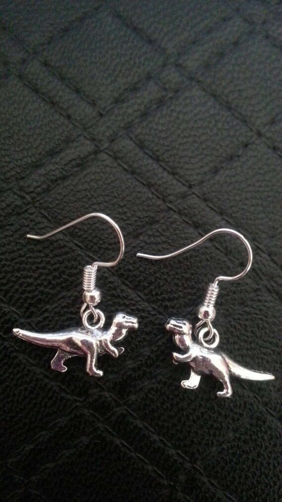 silver chain earrings mismatched trex charms long dangly punk trend dinosaur