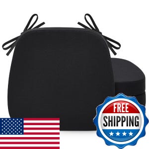 May include: A set of two solid black chair cushions with a rounded square shape and attached fabric ties at the top corners for securing to furniture. The cushions feature a smooth, uniform texture and a simple, functional design for seating.