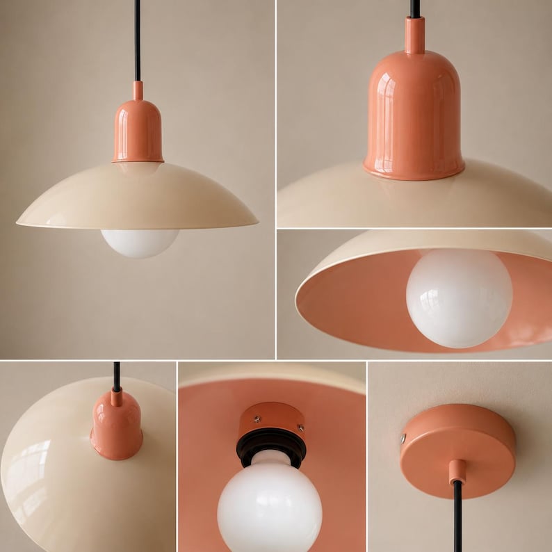 May include: A pendant light fitting featuring a wide, beige dome-shaped shade with a glossy finish. The top cap and ceiling canopy are a solid coral-pink colour. A black cord suspends the fitting, which includes a round, white frosted light bulb.