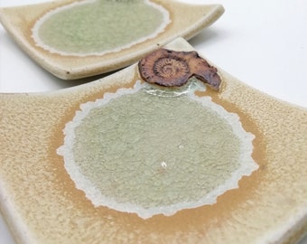 Square dish with 'sand and sea' theme and ammonite.  Ceramic with melted glass pool. For soap or rings.
