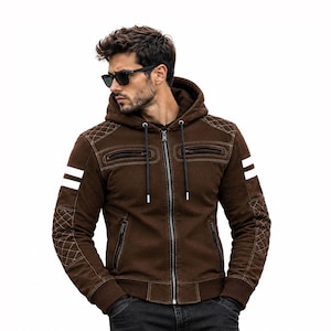 May include: A brown hooded jacket featuring a full-length front zipper, two chest pockets with zippers, and two lower side pockets. The sleeves include white horizontal stripes and quilted diamond-patterned shoulder and elbow patches.