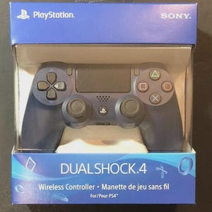 May include: A dark blue DualShock 4 wireless controller for PlayStation 4 in its original retail packaging. The box features the PlayStation and Sony logos, with the text DUALSHOCK 4 Wireless Controller For/Pour PS4 printed on the front.