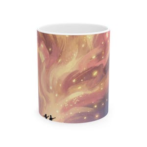 May include: White ceramic coffee mug featuring a vibrant, abstract design in shades of pink, yellow, and orange, with a starry effect. The design includes two small figures with arms raised, set against a swirling, painterly background.