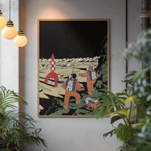 May include: A framed print depicting a retro space scene. Two astronauts in orange suits explore a lunar landscape with a red and white rocket. The background is a starry night sky, with a brown wooden frame.