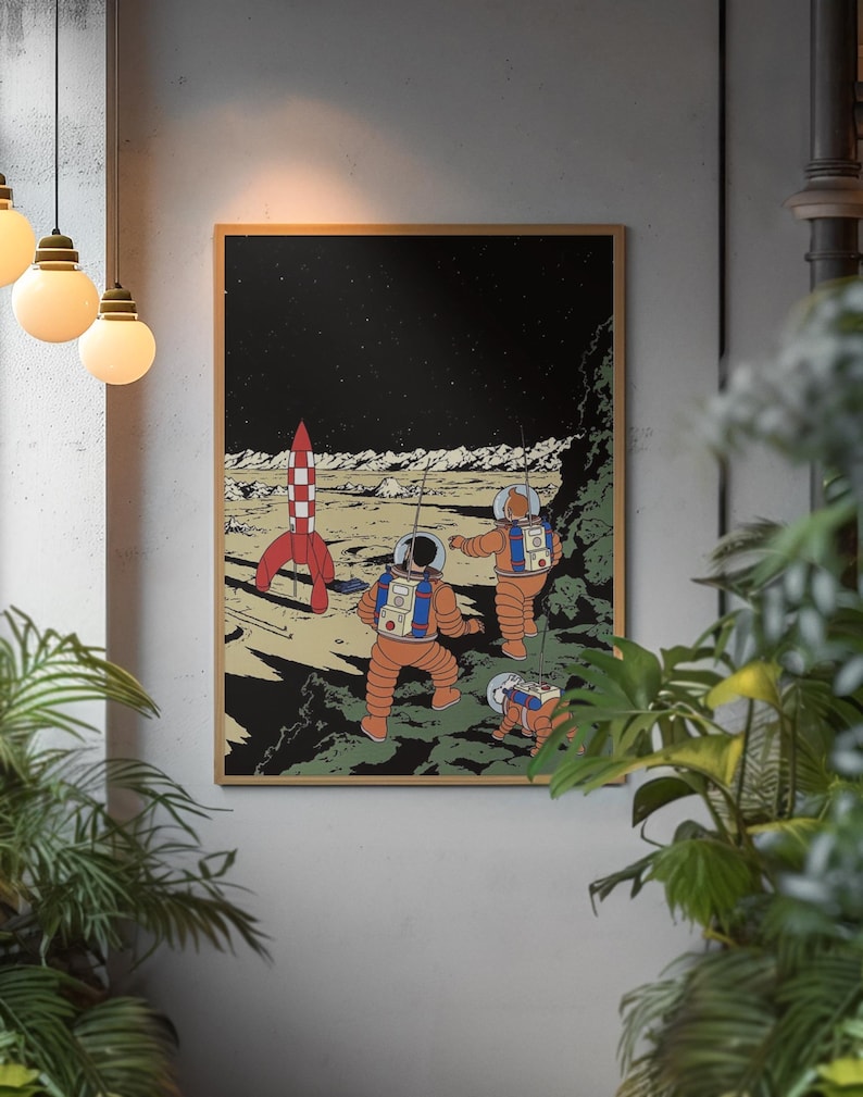 May include: A framed print depicting a retro space scene. Two astronauts in orange suits explore a lunar landscape with a red and white rocket. The background is a starry night sky, with a brown wooden frame.