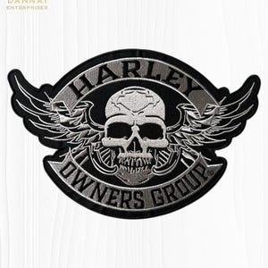 May include: A black and silver embroidered patch featuring a central skull design with wings. The text HARLEY is arched above the skull, and OWNERS GROUP is arched below. The design is bordered by a black edge on a white background.