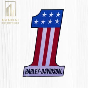 May include: A large embroidered patch in the shape of the number one, featuring a blue top section with six white stars and a lower section with vertical red and white stripes. The base of the patch displays the text HARLEY-DAVIDSON in black.
