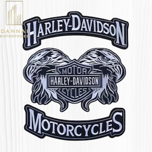 May include: A black and white embroidered patch set featuring the Harley-Davidson logo. The top rocker reads Harley-Davidson, the center shield displays Motor Harley-Davidson Cycles between two eagle heads, and the bottom rocker reads Motorcycles.