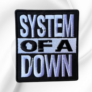May include: A rectangular embroidered patch with a black background and white stitched lettering. The text reads SYSTEM in the top section, OF A in the middle section, and DOWN in the bottom section, all in a bold, block-style font.