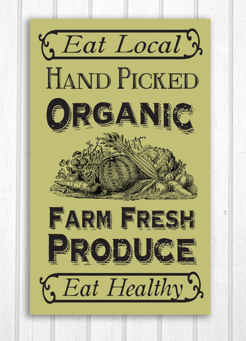May include: A vintage-style sign with a green background and black text that reads "Eat Local, Hand Picked Organic, Farm Fresh Produce, Eat Healthy". The sign features a black and white illustration of a basket of fresh produce.