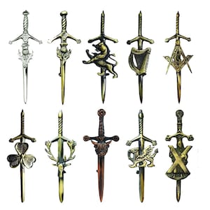 May include: A collection of ten decorative kilt pins shaped like miniature swords, each featuring distinct metallic finishes and unique emblems including a thistle, lion, harp, masonic square and compass, shamrock, stag, bull, dragon, and cross.