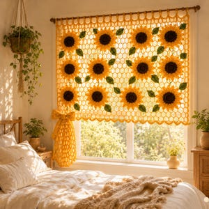 May include: A yellow crochet window curtain featuring a repeating honeycomb pattern and sunflower motifs with dark brown centers and green leaves. The curtain is gathered to one side with a matching yellow crochet tie-back bow.