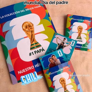 以下が含まれることがあります： 「#1 PAPÁ」と「Nuestro Héroe Favorito」の文字が入った、カラフルなアルバムとカードのコレクション。アルバムには金色のトロフィーと「World Cup」の文字が描かれています。「CHILL」の文字も表示されています。