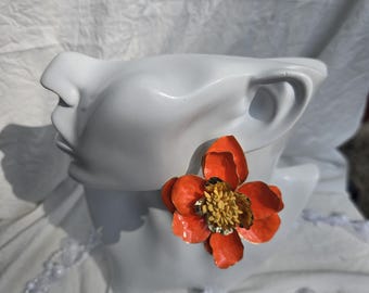Statement Earrings in orange, featuring a vibrant, multi-layered floral design.