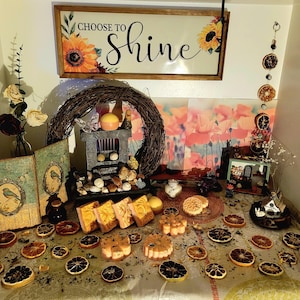 May include: A decorative display featuring a wooden sign with the words "Choose to Shine" and sunflower accents. The display includes dried orange slices, candles, and decorative soaps, creating a warm and inviting atmosphere.