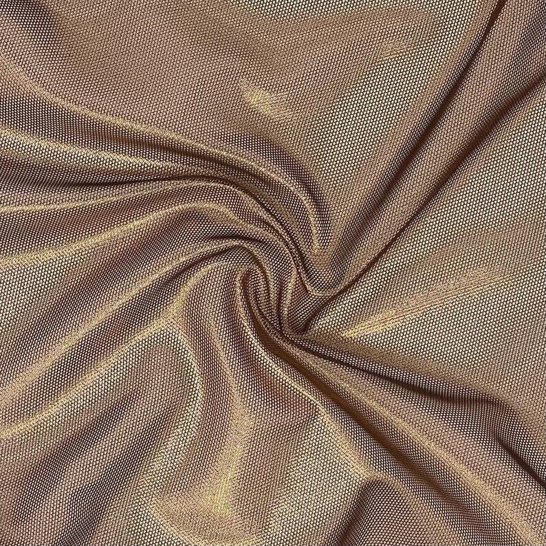 May include: A fine-mesh fabric in a metallic bronze tone featuring a dense, uniform grid pattern. The material is gathered into soft, flowing folds that create subtle highlights and shadows across the textured, semi-sheer surface.