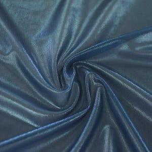 May include: A piece of fabric with a deep blue hue and a metallic, shimmering finish. The material is gathered in the centre, creating soft, flowing folds and highlights that emphasise the reflective, glossy texture of the textile surface.