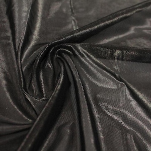 May include: A piece of black fabric with a subtle sheen and a fine, mesh-like texture. The material is draped to create soft folds and highlights, showcasing the reflective quality of the surface and the intricate, uniform weave of the textile.